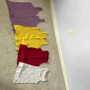 J crew light purple, American eagle white and Oakley fuscia and yellow tanks